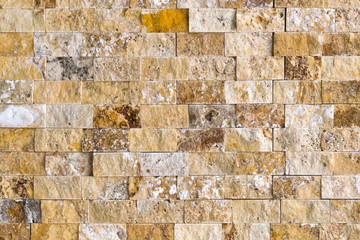 Yellow and brown wall with stone masonry, background, texture