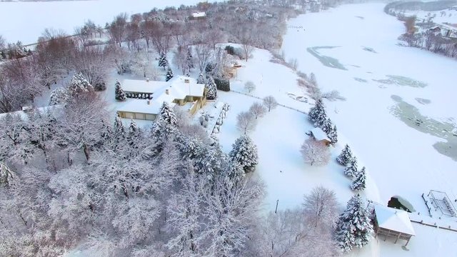 Beautiful riverfront homes buried under deep, fresh blizzard snow.
