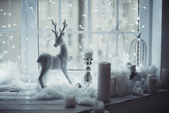the deer figure standing at the window on the background of Christmas decor. waiting for a miracle © angel_nt