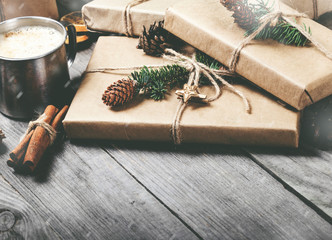 Bunch of christmas gifts and coffee on wooden table
