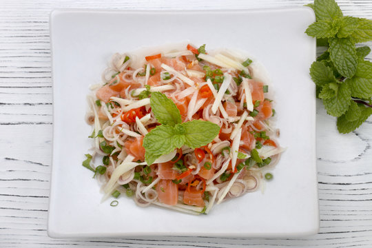 thai spicy salmon salad on wood table, thai food