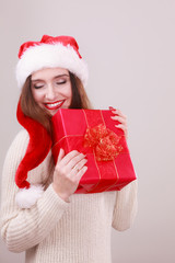 Woman holding gift box. Christmas time