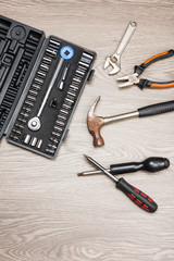 The repair tools is placed on the wooden table.