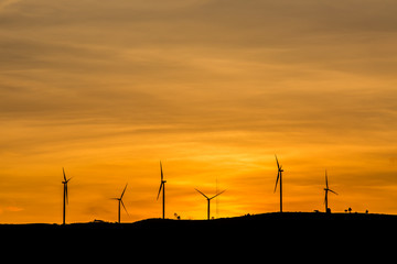 silhouette wind wheel on mountain