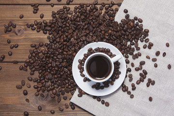 Still life with coffee in white mug and grains