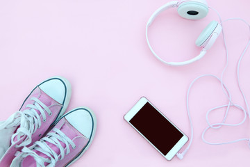 Smartphone mock up template with sneakers and cool headphones. View from above. Flat lay.PInk

