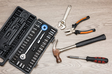 The repair tools is placed on the wooden table.