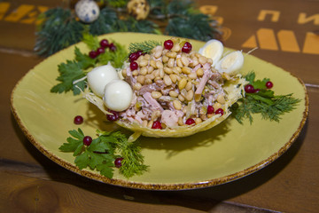Salad with meat, pine nuts and quail eggs.