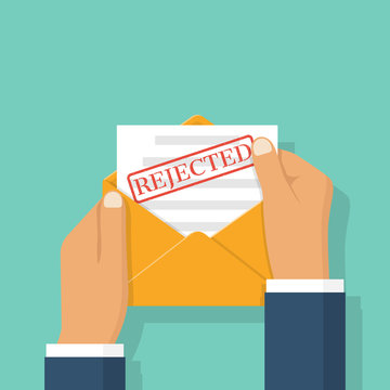 envelope in hands with letter Rejected