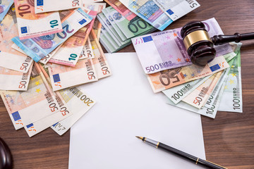 hammer with euro bills, empty note, pen