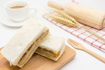 Katsu Sando (Japanese Pork Cutlet Sandwich), serve with napkin, cutlery Set and coffee cup on wooden table background, Closed up