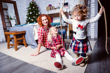 Modern family mother and children daughter christmas portrait. Decorated christmas tree, cozy atmosphere living room. Family Together Christmas Celebration Concept. Merry Christmas and Happy Holidays