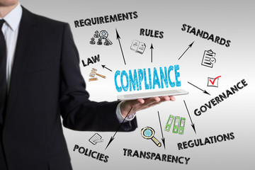 Compliance concept with young man holding a tablet computer