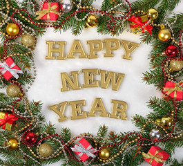 Happy New Year golden text and spruce branch and Christmas decor