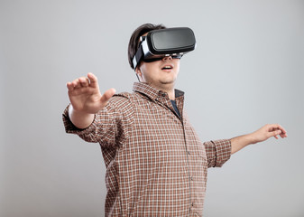 Happy young man using virtual reality headset