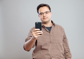 Young businessman taking photos with mobile phone