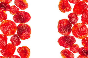 Fototapeta premium Dried cherries closeup on white background. Isolated. Decorative border of glossy red dried cherry. Dried fruit for vegetarian.