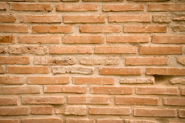 Wall of old broken bricks. Textured background. Toned