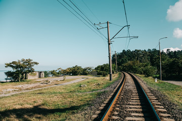 Fototapeta na wymiar Old railway on a Black sea coast in Georgia. Toned