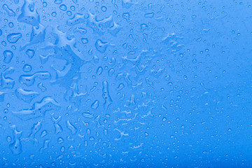 Drops of water on a color background. Blue. Selective focus. Sha