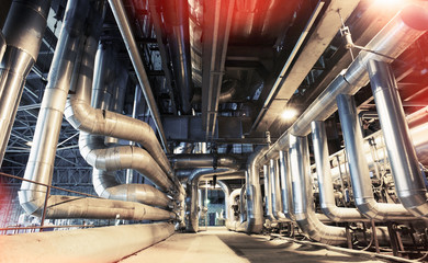 Equipment, cables and piping as found inside of a modern industr