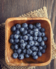 ripe sweet blueberries on wooden table