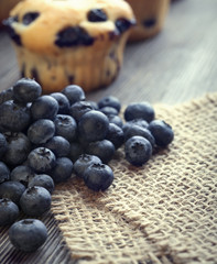 muffin with blueberries on a wooden table. fresh berries and swe