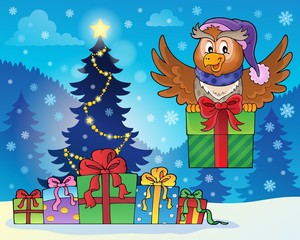 Owl with gift near Christmas tree