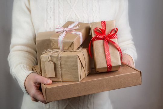 Female holding stack of christmas presents