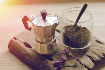 Blur Moka pot and  coffee on wood wite sunset light background.