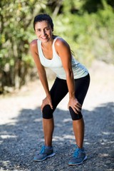 Woman smiling and taking a break during sport 