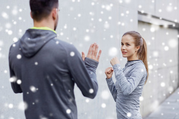 happy woman with coach working out strike outdoors