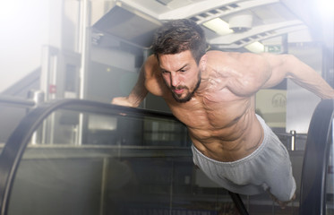 Handsome man with naked torso doing exercise.