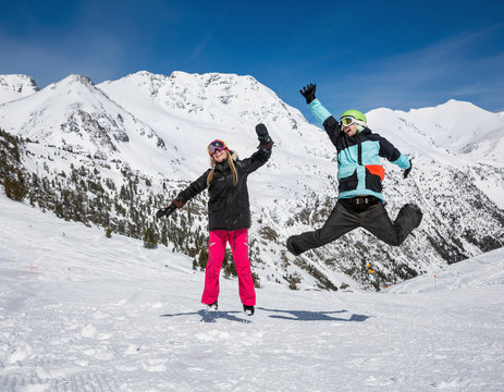 Happy couple jumping in mountains