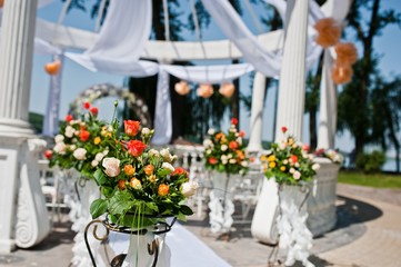wedding arch with chairs and many flowers and decor