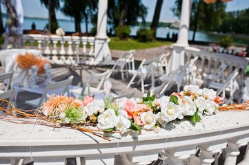 wedding arch with chairs and many flowers and decor