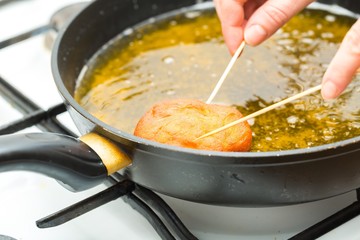 Donuts frying in deep fat