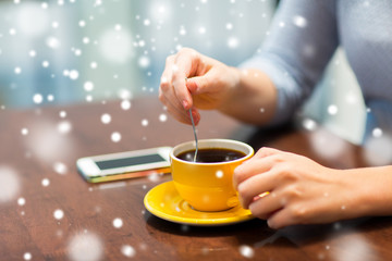 close up of woman with smartphone and coffee