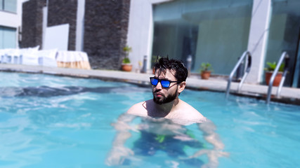 A boy with sunglasses in Swimming Pool 