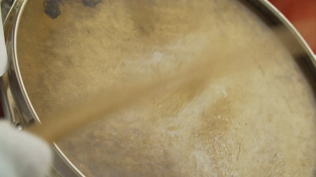 closeup drumstick hits the drum