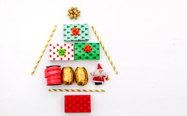 Christmas tree made of colorful presents and decorations. Flat lay. Holiday concept.

