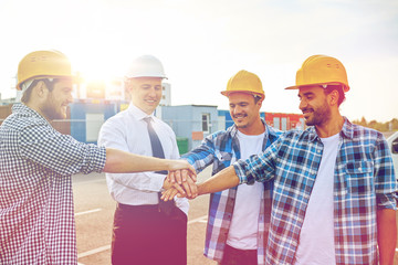 builders and architects with hands on top
