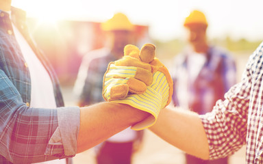 close up of builders hands making handshake