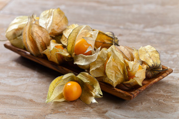 Physalis in wooden dish