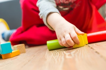 Small boy playing with wooden blocks