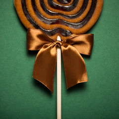 Brown Sweet Lollipop For Children On Green Background