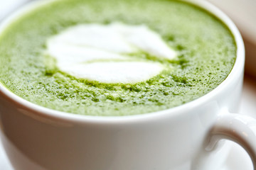 close up of cup with matcha green tea latte