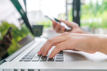 Business woman hand with Financial charts and laptop on the tabl