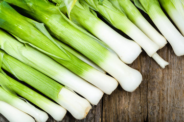 Fresh leeks, green vegetables, farm fresh produce on farmer table