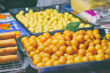 Spring Rolls and Balls at Thai street night market. Deep fried snacks, spring rolls with different fillings and thai sweet chili sauce, fresh and hot food